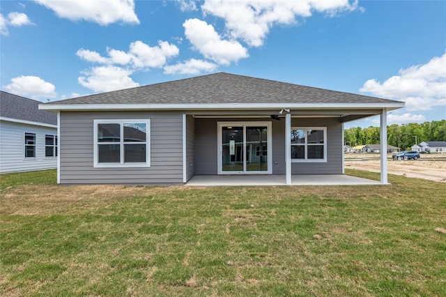 back of property with a patio, a yard, and ceiling fan