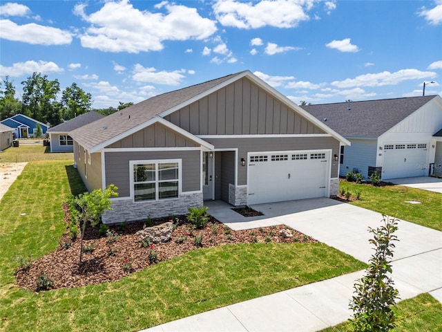 view of front of property with a front yard and a garage