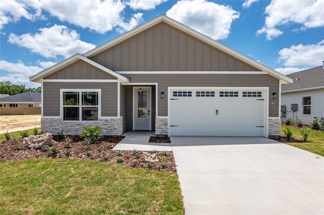 craftsman-style house featuring a front yard and a garage