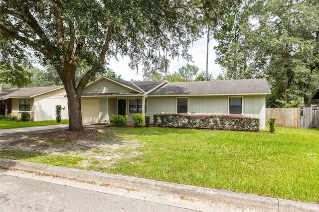 ranch-style home with a garage and a front lawn