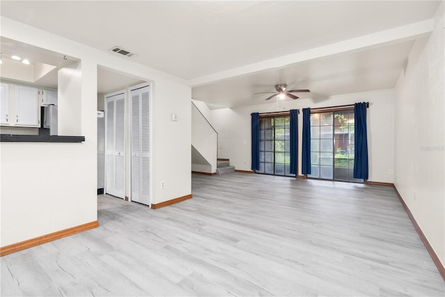 unfurnished living room featuring light wood-type flooring and ceiling fan