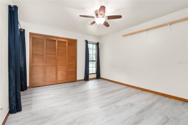 unfurnished bedroom featuring a closet, light hardwood / wood-style floors, and ceiling fan