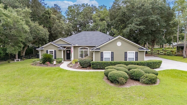 view of front of home with fence and a front yard