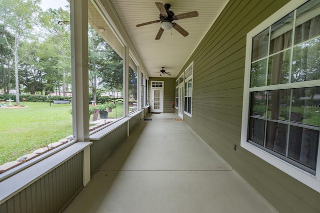 unfurnished sunroom with ceiling fan