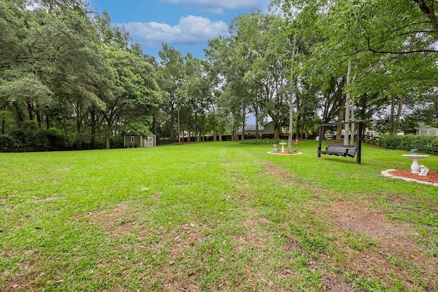 view of yard featuring a shed and an outdoor fire pit