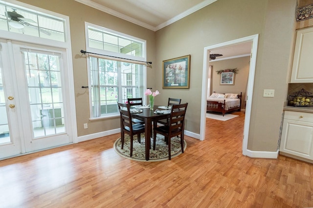 dining area featuring ceiling fan, light wood-type flooring, and crown molding