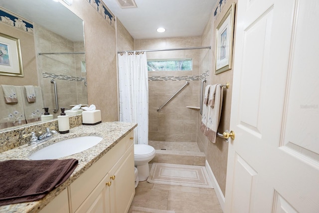 full bath with vanity, tile patterned floors, toilet, a tile shower, and visible vents