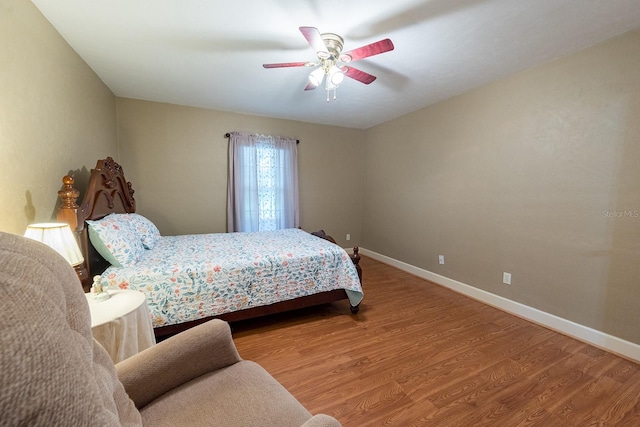 bedroom with ceiling fan and hardwood / wood-style floors