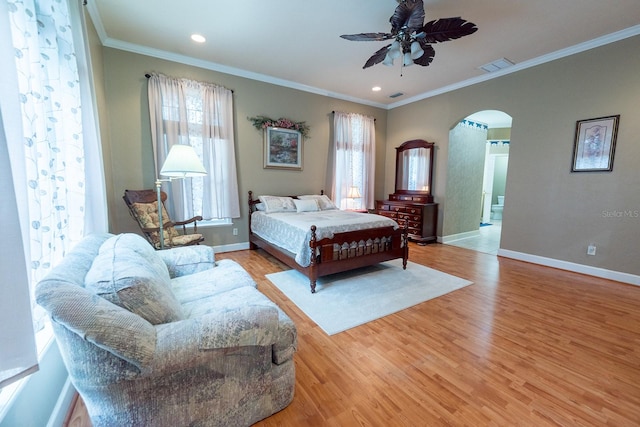 bedroom featuring light wood-type flooring, crown molding, and ceiling fan