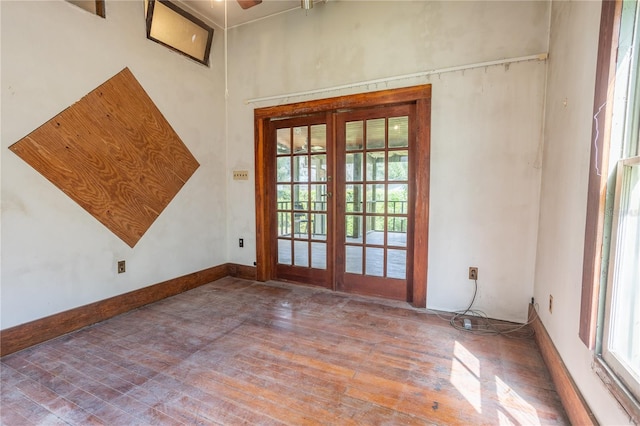 interior space with ceiling fan, french doors, and hardwood / wood-style flooring