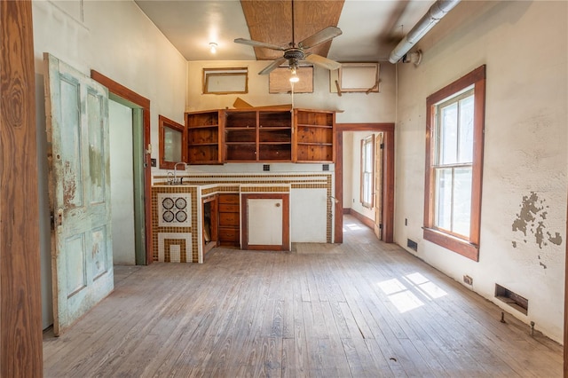 kitchen featuring sink, ceiling fan, and light hardwood / wood-style flooring