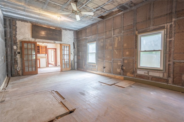 unfurnished room featuring hardwood / wood-style floors, ceiling fan, and french doors