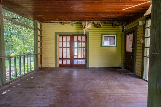 unfurnished sunroom featuring wood ceiling and french doors