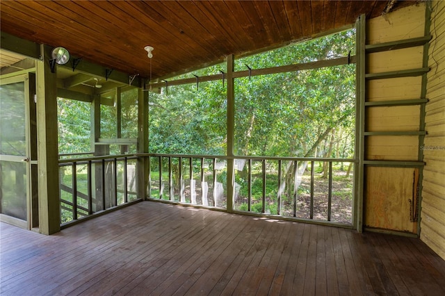 unfurnished sunroom with a healthy amount of sunlight and wood ceiling