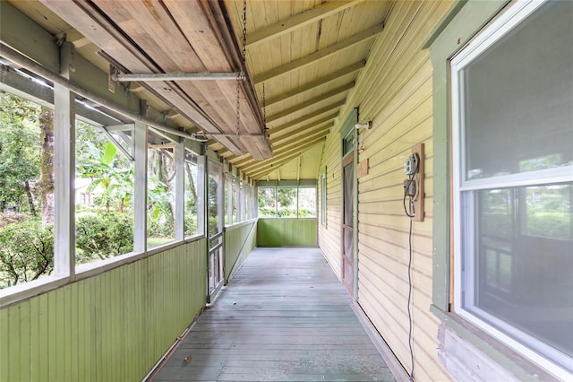 unfurnished sunroom featuring lofted ceiling and wooden ceiling