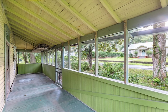 unfurnished sunroom featuring wood ceiling, vaulted ceiling with beams, and plenty of natural light