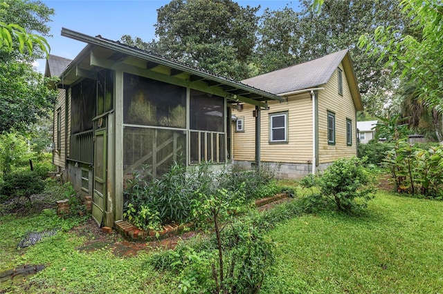 exterior space featuring a front yard and a sunroom