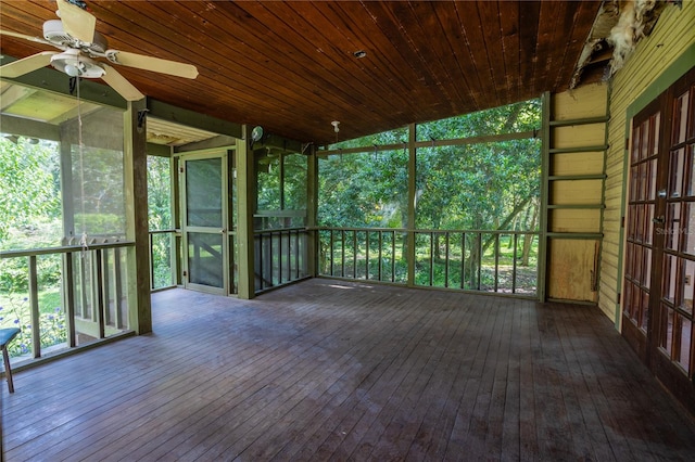 unfurnished sunroom with ceiling fan and wooden ceiling