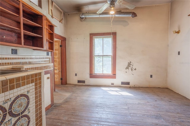 unfurnished living room with light hardwood / wood-style floors and ceiling fan