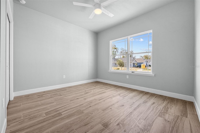 empty room with light wood-type flooring and ceiling fan