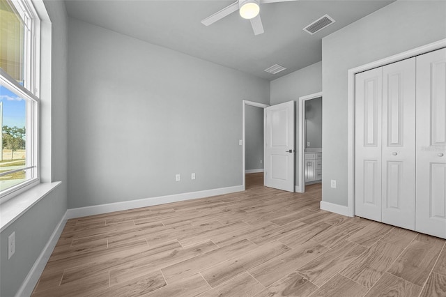 unfurnished bedroom featuring ceiling fan, light hardwood / wood-style flooring, and a closet