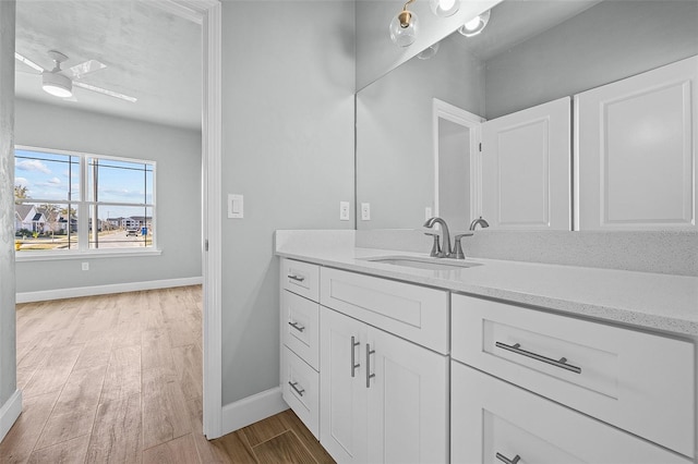 bathroom with vanity, hardwood / wood-style floors, and ceiling fan