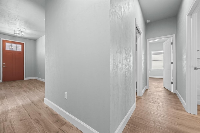 corridor with light wood-type flooring