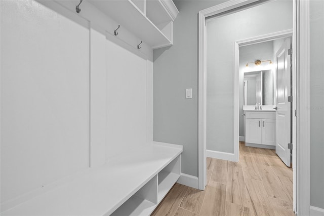 mudroom featuring sink and light hardwood / wood-style floors