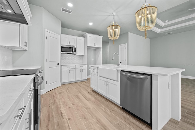 kitchen featuring an inviting chandelier, appliances with stainless steel finishes, sink, and white cabinetry