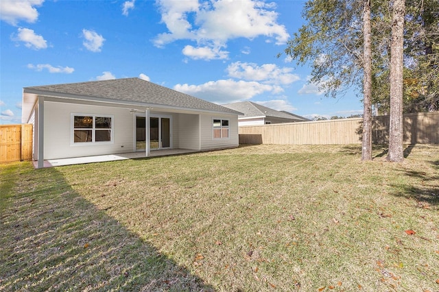 back of house with a patio and a yard