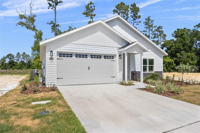 view of front of home with a garage and central air condition unit