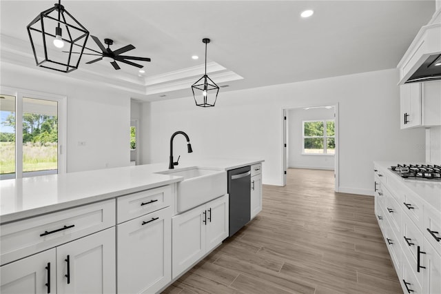 kitchen with a wealth of natural light, sink, stainless steel appliances, and decorative light fixtures