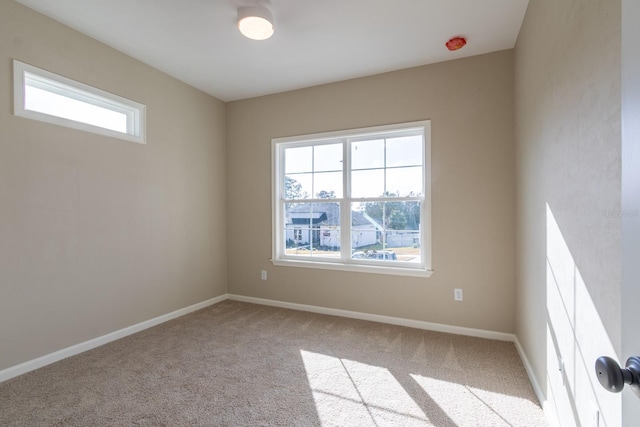 spare room with light colored carpet and a healthy amount of sunlight