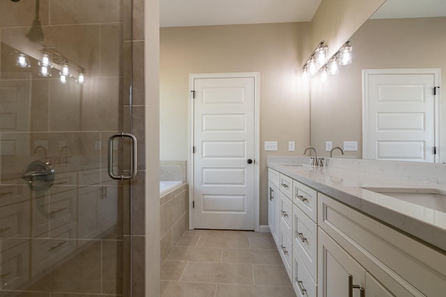 bathroom featuring tile patterned flooring, shower with separate bathtub, and vanity