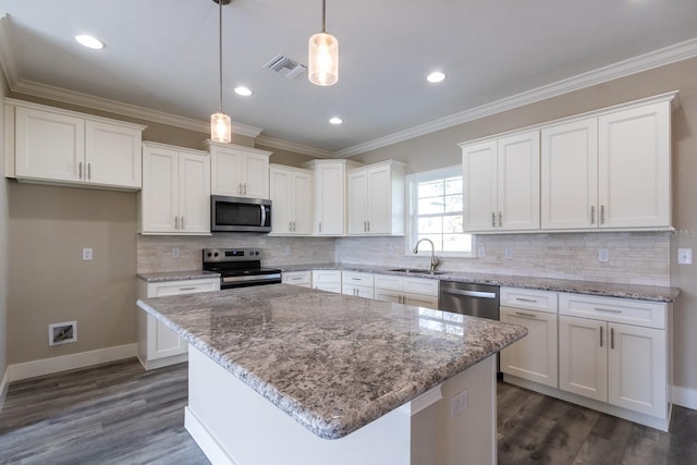 kitchen with white cabinetry, a center island, hanging light fixtures, stainless steel appliances, and dark hardwood / wood-style flooring