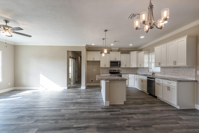 kitchen with a center island, sink, dark hardwood / wood-style flooring, white cabinetry, and stainless steel appliances