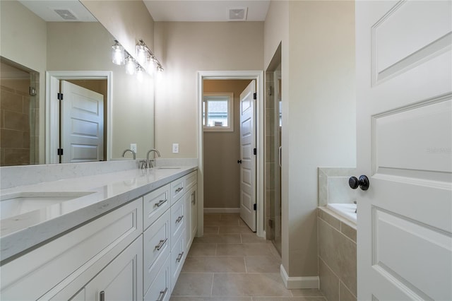 bathroom featuring tile patterned floors, vanity, and separate shower and tub