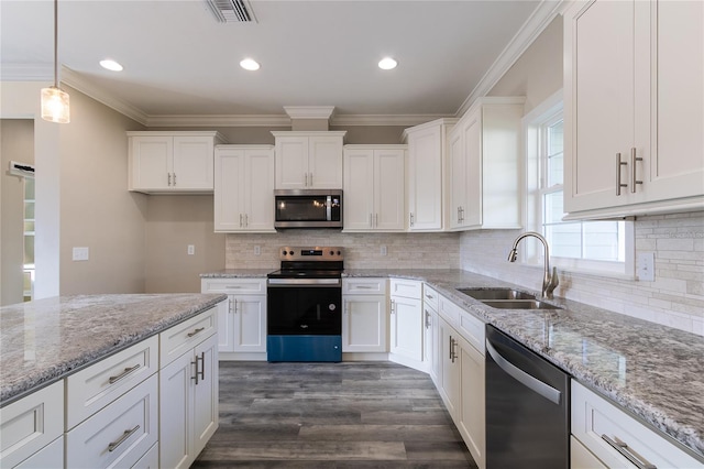 kitchen featuring pendant lighting, dark wood-type flooring, sink, white cabinetry, and stainless steel appliances