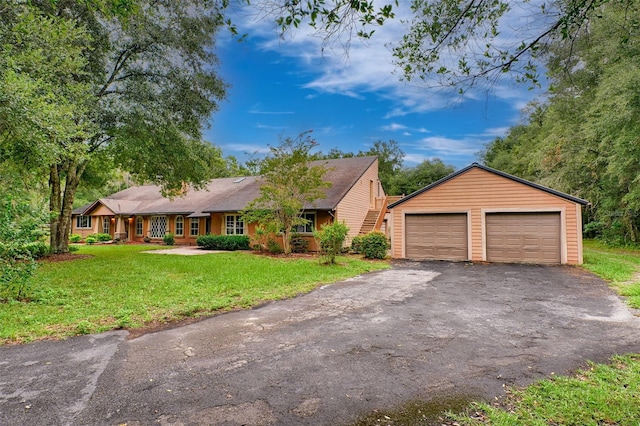 ranch-style home with a front yard and a garage