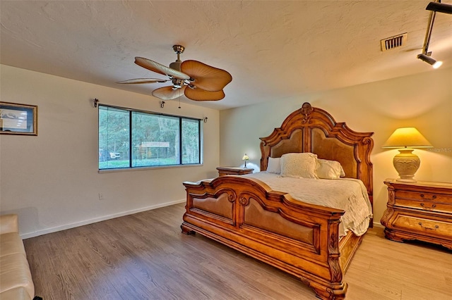 bedroom with hardwood / wood-style floors and ceiling fan