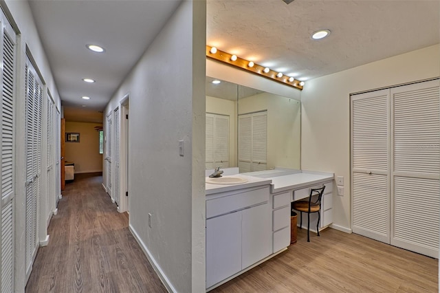 bathroom featuring wood-type flooring and vanity