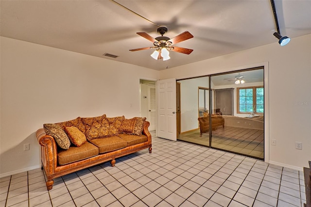 living room with light tile patterned floors and ceiling fan