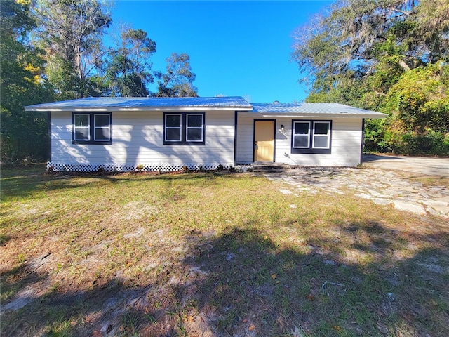 ranch-style home with a front lawn