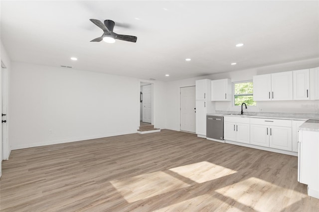 kitchen with sink, white cabinetry, ceiling fan, light wood-type flooring, and stainless steel dishwasher