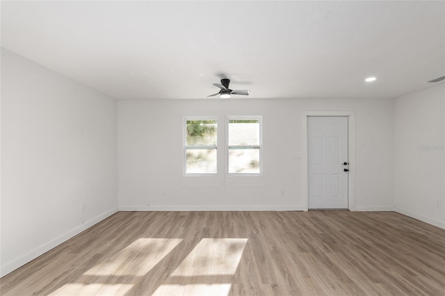 empty room featuring a ceiling fan, baseboards, wood finished floors, and recessed lighting