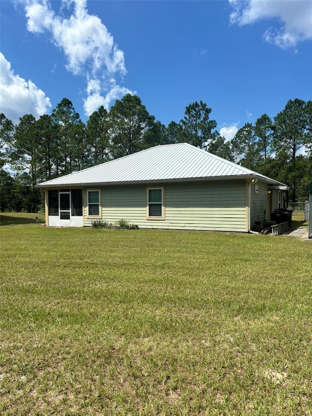 view of side of property with a lawn