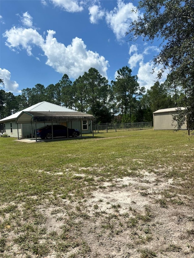 view of yard with a carport and an outdoor structure