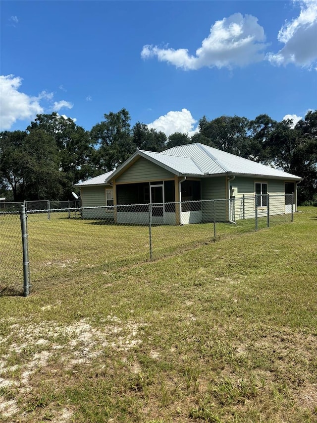 rear view of property featuring a lawn