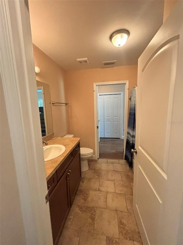 bathroom with vanity and toilet