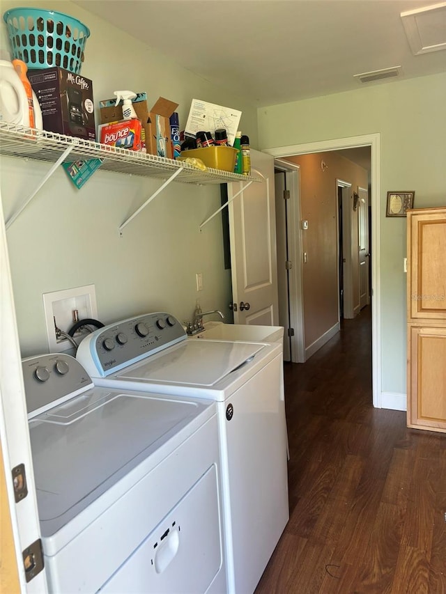 laundry room with dark hardwood / wood-style floors, washer and dryer, and sink